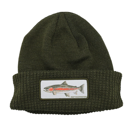 dark green knit hat with a cuff and a patch of a rainbow trout on the front