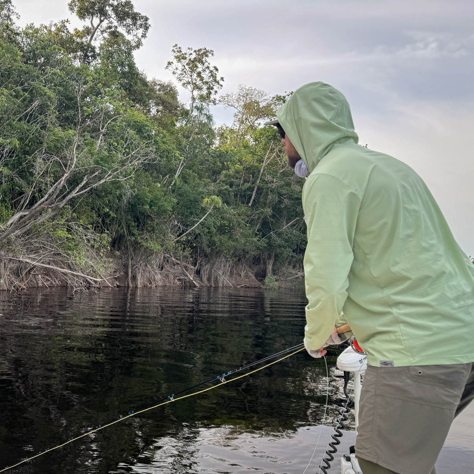 Man fishing with a lichen flolite sun hoody on
