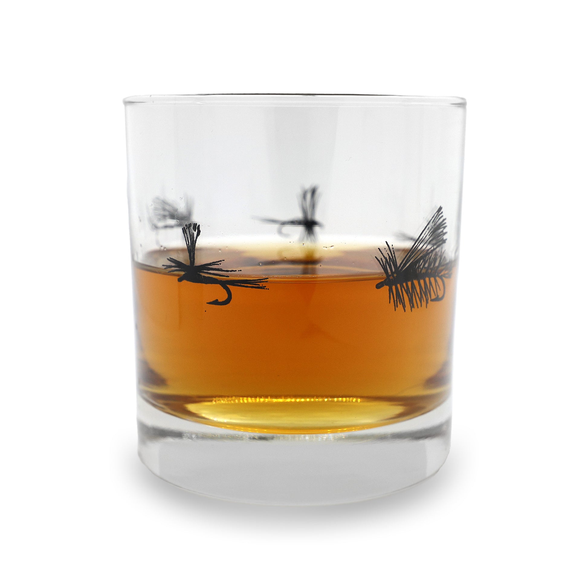 a clear old fashioned with dry flies around the center in black ink. the glass has a pour of brown water