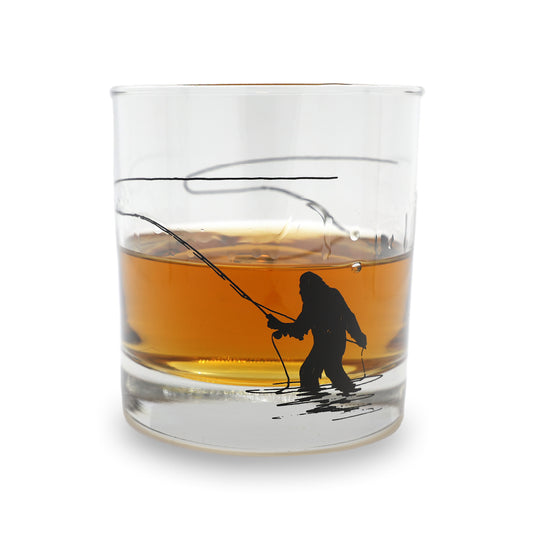 drinking glass with a printed sasquatch casting a fly rod on it