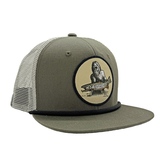 Green front and light gray mesh back hat with a black rope showing a patch of a squatch holding a fish