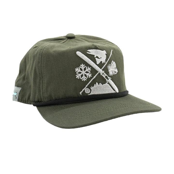 all green cloth hat with white embroidery of a ski and fly rod cross in silhouette of mountains, fly, snowflake and fish